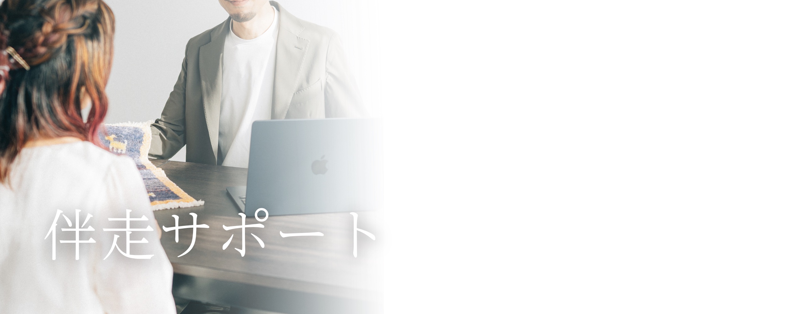 伴走サポート — 机をはさんで話す親御さんとスタッフ
